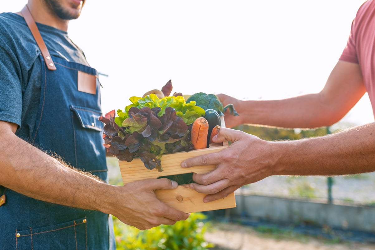 Local farmer talks with customer at farmers' market